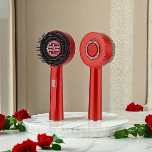 Two red hair styling tools on a marble stand with roses around, against a beige wall.